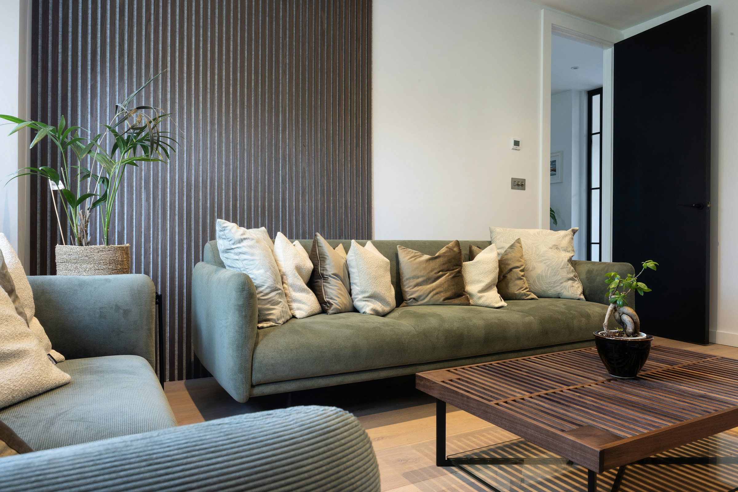 Warm wood-lined residential lobby at My Ensō Lofts